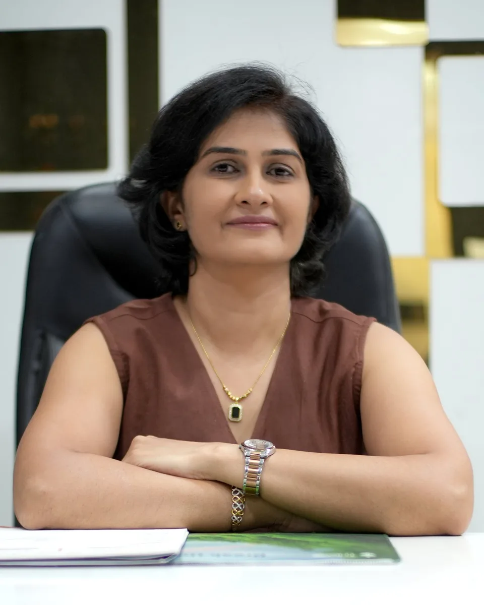 Dr. Daksha Patel, MBBS, MD (Skin & VD), at her desk at Skin Essence