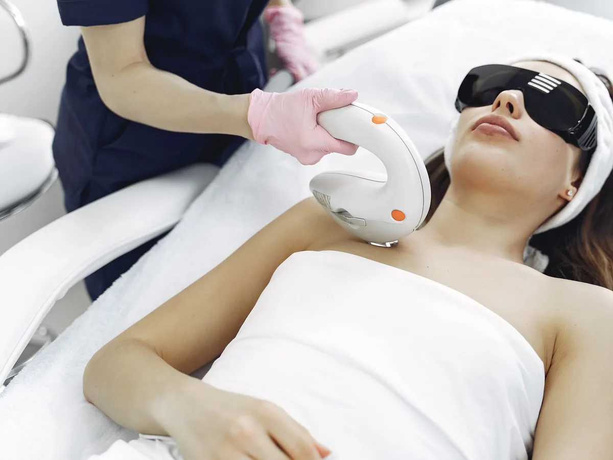 Laser toning handpiece being used on a patient's face for pigmentation