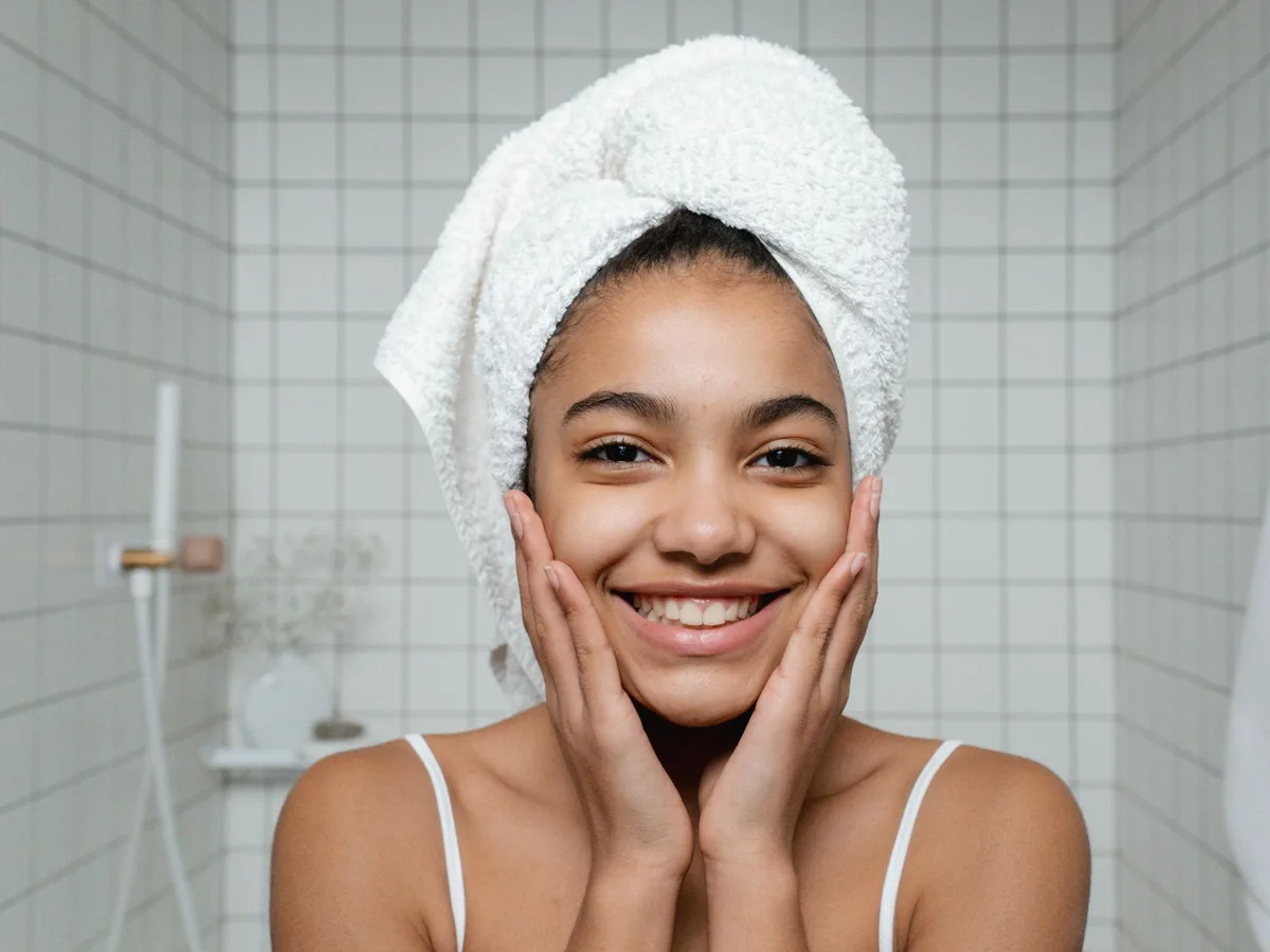 Smiling woman with glowing, healthy skin after a facial routine